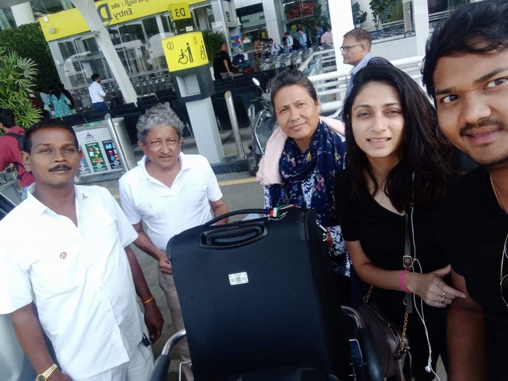 Happy guests with our driver at the airport – Om Shakthi Travels, Chennai