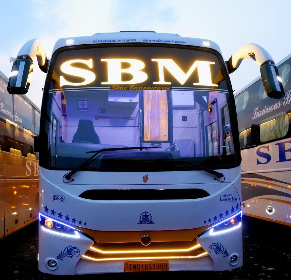 Luxury coach with its lights on at night – Om Shakthi Travels, Chennai