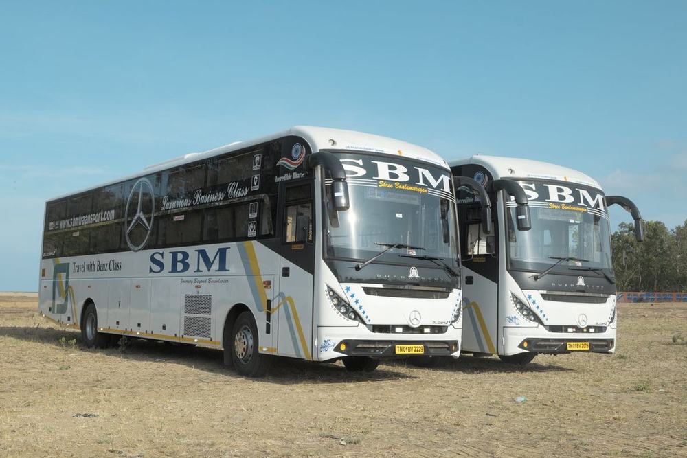 Two luxury AC coaches parked side by side – Om Shakthi Travels, Chennai